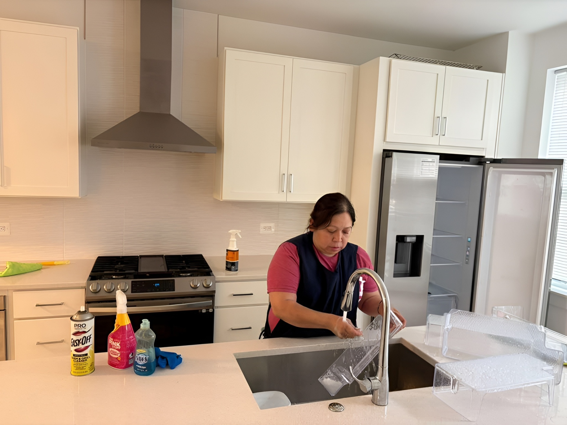 Professional cleaner using eco-friendly products in a Sterling, VA kitchen